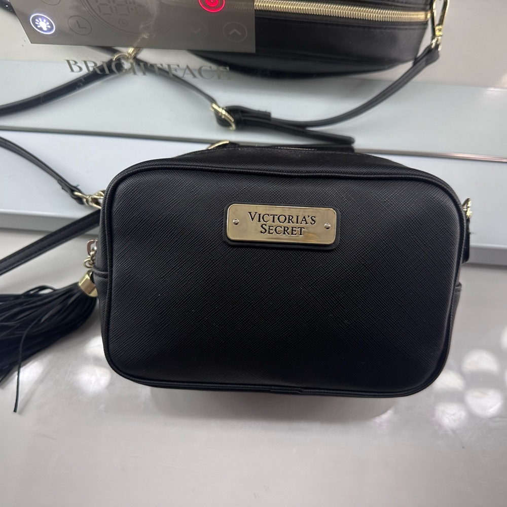 Small black Victoria’s Secret purse with adjustable strap. Excellent condition